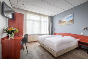 TV a/nebo společenská místnost v ubytování Two Brothers Hotel Astoria