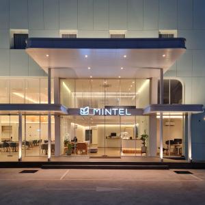 a building with a united sign on the front of it at Mintel Huamark in Bangkok