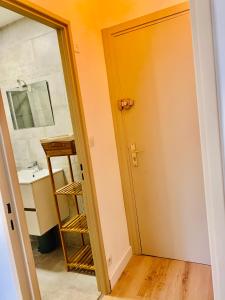 un baño con una puerta que conduce a un lavabo en GM Studio, en La Grande-Motte