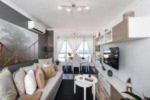 a living room with a couch and a table at Wonderful apartment in Puerto Marina in Benalmádena