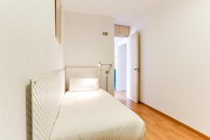 1 dormitorio con 1 cama blanca en una habitación en Luminous 2 Bedroom next to Sagrada Familia, en Barcelona