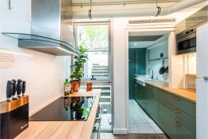 a kitchen with green cabinets and a counter at Boho Room in the City with Remarkable Rooftop in Perth