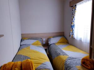 two beds sitting next to each other in a bedroom at The Abi Joseph @Combe Haven in Hastings