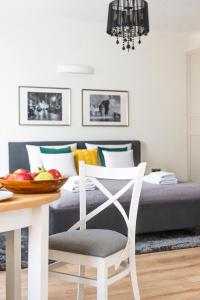 a bedroom with a bed with a bowl of fruit on a table at Right Stay Studio in Gdańsk
