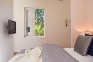 a bedroom with a bed and a window at Sun-Drenched 1 Bed Studio Apartment In Newtown in Sydney