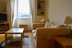 a living room with a couch and a table at Central and Homely One Bedroom Flat in Edinburgh