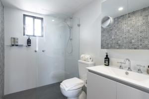 a bathroom with a toilet and a sink and a shower at Modern 1 Bedroom Apartment In The Italian Forum in Sydney