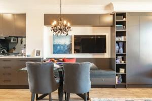 a kitchen with a dining room table and chairs at Modern 1 Bedroom Apartment In The Italian Forum in Sydney