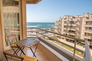 a balcony with a bench and a view of the ocean at BARRAMARES 5 - 4ºandar PISCINA EXTERIOR VISTA MAR in Ovar