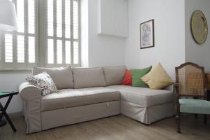 a living room with a couch with pillows on it at Quiet Ground Floor Mews Flat and parking in Edinburgh
