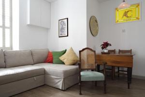 a living room with a couch and a table at Quiet Ground Floor Mews Flat and parking in Edinburgh