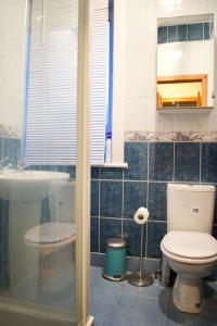 a bathroom with a toilet and a glass shower at Newly Refurbed Home with Free Parking in Edinburgh