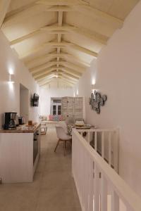 a kitchen and living room with a wooden ceiling at La Maison de Marie Geraldine in Hydra