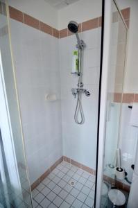 a bathroom with a shower with a toilet at Cute Studio Apartment in Maroubra in Sydney