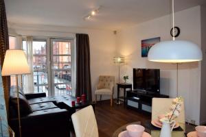 a living room with a couch and a tv at 2 Bedroom Apartment near historical Christchurch in Dublin