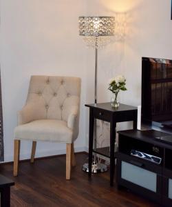 a living room with a chair and a table with a lamp at 2 Bedroom Apartment near historical Christchurch in Dublin