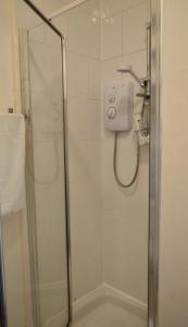a shower in a bathroom with a glass door at Sophisticated and Bright One Bed in Leith in Edinburgh