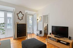 a living room with a large flat screen tv at Stunning 1 Bedroom Apartment near Alfama in Lisbon