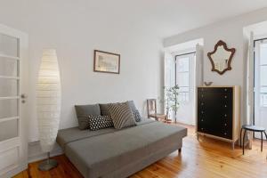 a living room with a couch and a table at Stunning 1 Bedroom Apartment near Alfama in Lisbon