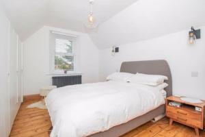 a bedroom with a white bed and a wooden floor at Modern and Chic 2 Bedroom in Bristol in Bristol