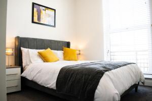 エディンバラにあるBeautifully Renovated Apartment -Central Edinburghのベッドルーム1室(大型ベッド1台、黄色い枕付)