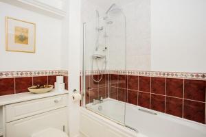 a bathroom with a shower and a tub and a toilet at 1 Bedroom Apartment on The Riverbank Near St Paul's in London
