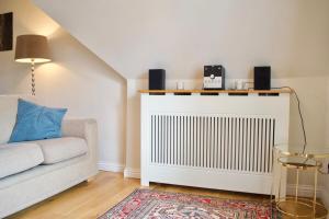 a living room with a white radiator and a couch at Modern and Charming 2 Bedroom Old Town Apartment in Edinburgh