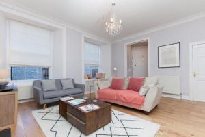 a living room with a couch and a table at Beautifully Modernised New Town Home in Edinburgh