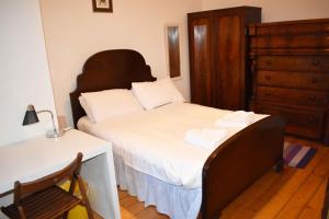 a bedroom with a bed with a dresser and a desk at Traditional Apartment oer the Meadows in Edinburgh