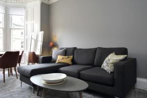 a living room with a couch and a table at Stylish 2 Bedroom Bruntsfield Apartment in Edinburgh in Edinburgh