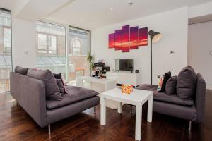 a living room with two couches and a tv at Beautiful Newly Renovated 2 Bed Apartment in Bank in London