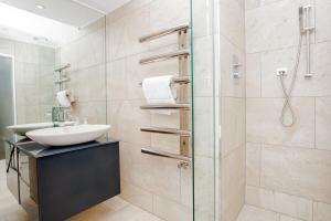 a bathroom with a sink and a glass shower at Beautiful Newly Renovated 2 Bed Apartment in Bank in London