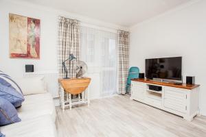 a living room with a white couch and a flat screen tv at Modern and Spacious Central 1 Bedroom Apartment with Balcony in London