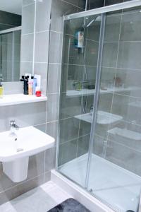 a bathroom with a shower and a sink at Modern Apartment in Edinburgh in Edinburgh