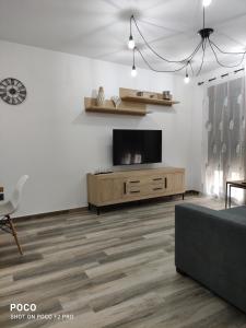 a living room with a flat screen tv on a wall at Casa Rural Lavernia in Cabanes