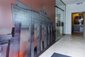 a wall in a hallway with a painting of buildings at Pension Berlin in Cheb