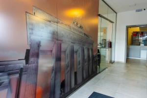 a wall with a painting on the wall in a hallway at Pension Berlin in Cheb +22 photos