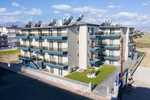 an apartment building with a rooftop garden on the water at ASTERAS STUDIOS in Paralia Katerinis