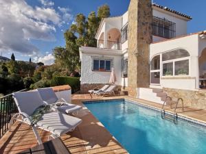 a villa with a swimming pool and a house at Casa Ancladero Room W big balcony and lovely view in Fuengirola