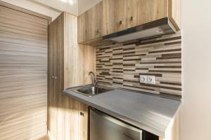 レプトカリヤにあるSunshine Apartmentsのシンクと電子レンジ付きのキッチン +30枚の写真