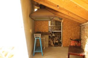 a kitchen with a stove and a blue ladder at Pamir Alibaba Hotel in Khorog