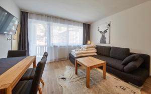a living room with a couch and a table at Appartement Timeout in Saalbach Hinterglemm