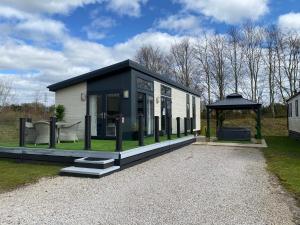 a tiny house with a gazebo in a yard at Silverdale Lodge Hot Tub & Wifi in Warton