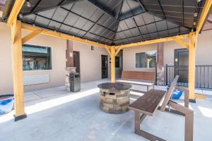 a patio with a bench and a fire pit at Kanab Suites in Kanab