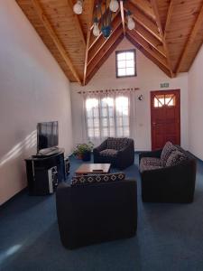 a living room with two couches and a tv at La hogareña in El Calafate