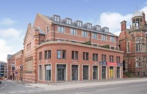 a large brick building on the corner of a street at The Old Fire Station Luxury Apartment in York