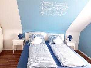 a bedroom with two beds and two night stands at Ferienwohnung Am Damm in Wesel
