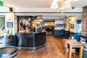 a bar in a restaurant with a counter and tables at Grantham Arms in Boroughbridge