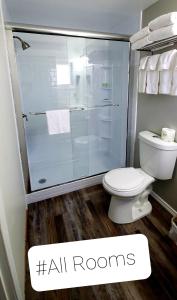 a bathroom with a toilet and a glass shower at Ogunquit Tides in Ogunquit