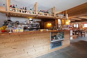 a bar in a restaurant with a lot of bottles at B&B La Locanda in Macugnaga +16 photos